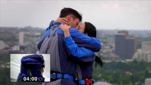 Sam Wood and Nina beat the world on-screen kissing record atop the Sydney Harbour Bridge.