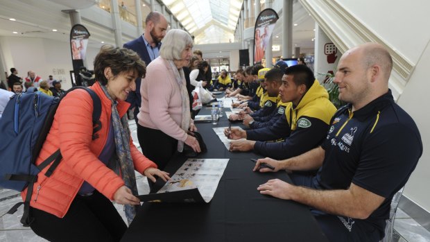 Rosario Lopez, a visiting professor from Colombia, gets an autograph from Brumbies captain Stephen Moore.