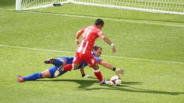 Caught: Adelaide goalkeeper Eugene Galekovic blocks an attempt by Heart's Michael Mifsud on Sunday.