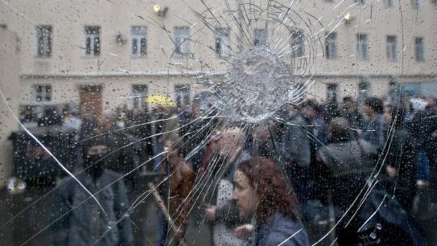 Pro-Russian protesters, seen through the cracked window of a police van, stand in the grounds of the police headquarters in Odessa.