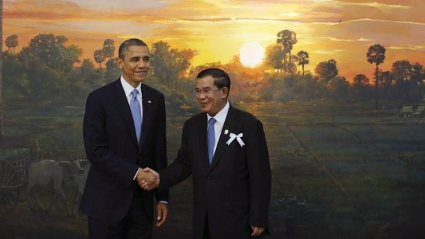 US President Barack Obama shakes hands with Cambodia's Prime Minister Hun Sen.
