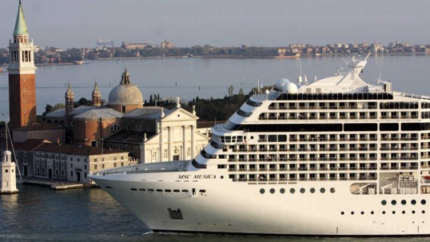 Big visitor ... the cruise ship MSC Musica dwarfs the church of San Giorgio Maggiore as it arrives in Venice.