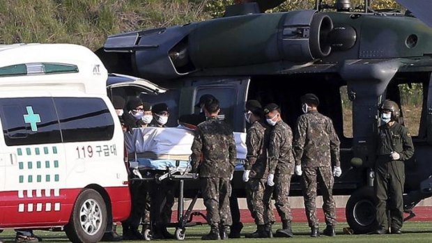 Soldiers carry the bodies of passengers recovered from the Sewol.