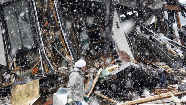 Snow has begun to fall over parts of Japan's worst-hit areas.