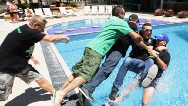 In at the deep end ... Danny Green is pushed into the pool after a press conference.