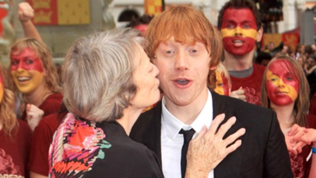 Red rules ... Rupert Grint gets a kiss from Harry Potter co-star Maggie Smith.