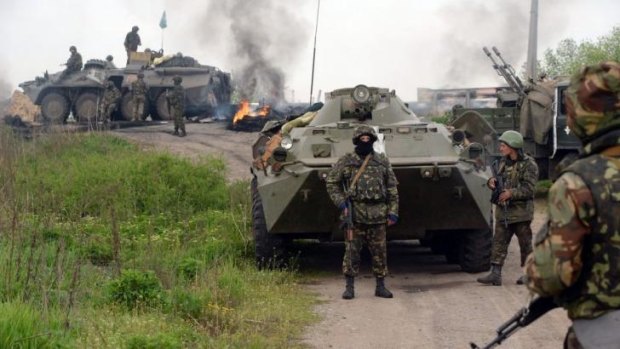 Ukrainian soldiers guard a checkpoint they seized in Andreevka, seven kilometres from the centre of Slaviansk, on Friday.