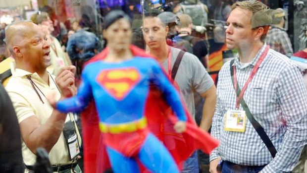 Super, man ... attendees debate the merits of a Superman figurine at Comic-Con 2014.