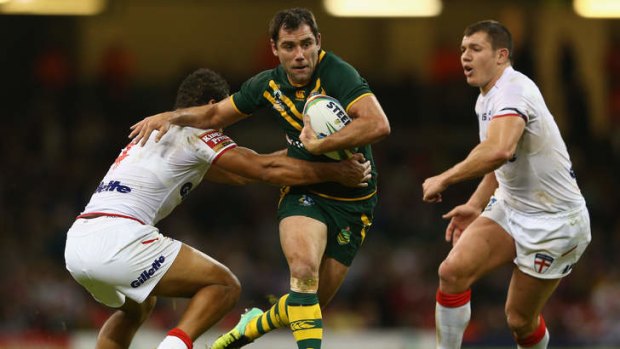 Kangaroos captain Cameron Smith palms off Leroy Cudjoe of England during the Rugby League World Cup Group A match at the Millennium Stadium in Cardiff.