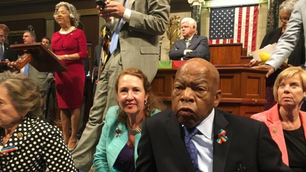 Democrat members of Congress including Representative John Lewis, center, and Elizabeth Esty as they participate in sit-down protest.