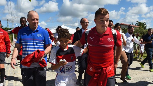 Bundle of energy: Switzerland's midfielder Xherdan Shaqiri with Brazilian children in Porto Seguro.