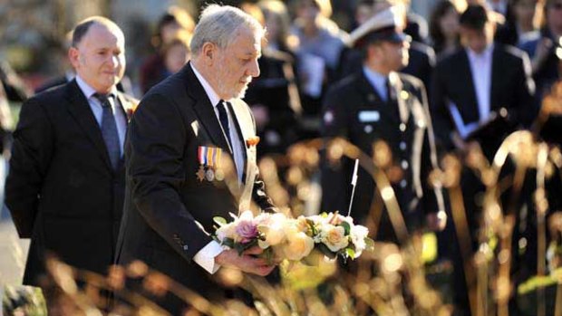 John Guest with a wreath at the Fromelles commemorative service at the Shrine of Remembrance.