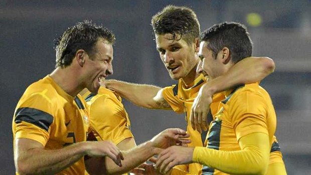 Young and old: Socceroos skipper Lucas Neill (left) celebrates Australia's third goal against Canada by Mathew Leckie (right), his first for his country.