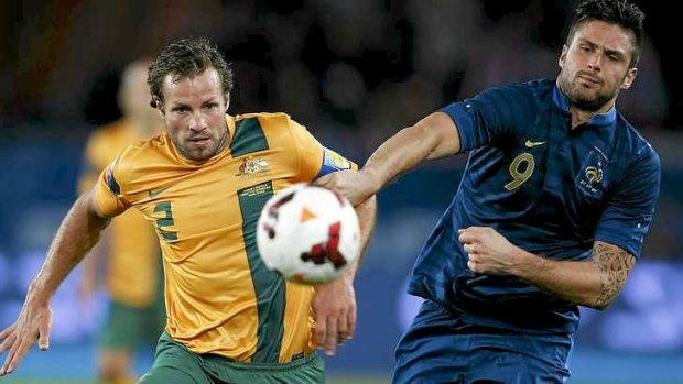 Socceroos captain Lucas Neill (L) tangles with Olivier Giroud during the friendly against France.