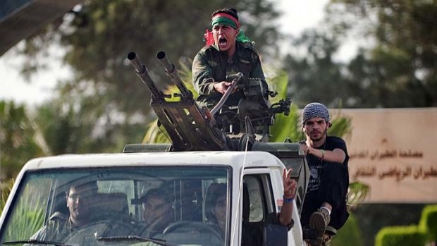 Libyan forces arrive at Tripoli airport after it was overrun by militiamen.
