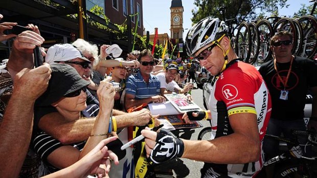 Lance Armstrong signs autographs in 2011.