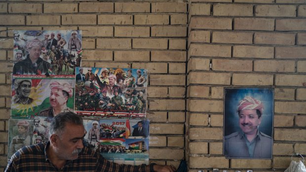 Photos of Masoud Barzani hang on the walls of the central bazaar in Irbil, Iraq.