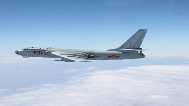Incoming: A Chinese military plane H-6 bomber flies through airspace between Okinawa prefecture's main island and the smaller Miyako island in southern Japan, out over the Pacific.