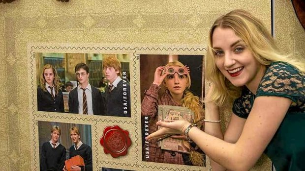 Evanna Lynch, who played Luna Lovegood in the Harry Potter films, with a selection of the USPS Harry Potter Limited-Edition Forever stamp collection.