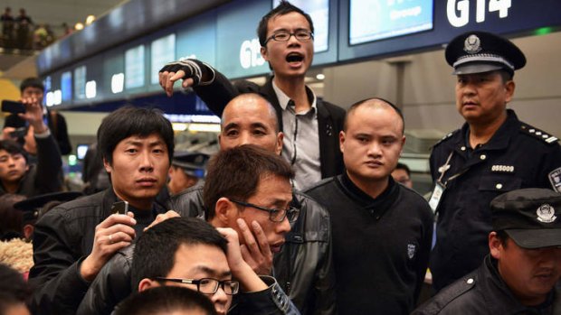 Travellers argue with police and airline staff at Changshui International Airport in Kunming.