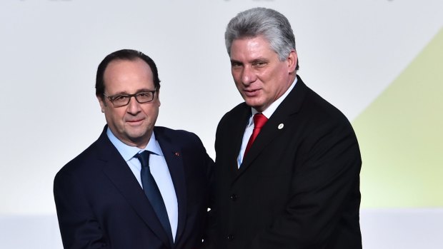 French President Francois Hollande, left, greets Miguel Diaz-Canel Bermudez at the Paris United Nations Climate Change Conference in November 2015.