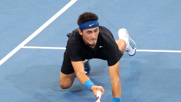 Tough day out &#8230; Bernard Tomic dives for a volley in his semi-final defeat against Andy Murray in Brisbane yesterday.