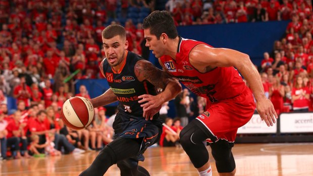 Talisman: Cairns guard Scottie Wilbekin drives to the basket against Perth defender Drake U'u during game two of the NBL semi-finals series between the Wildcats and the Taipans at Perth Arena.