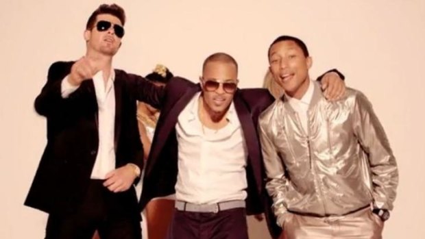 Robin Thicke, rapper T.I. and Pharrell Williams performing <i>Blurred Lines</i>.