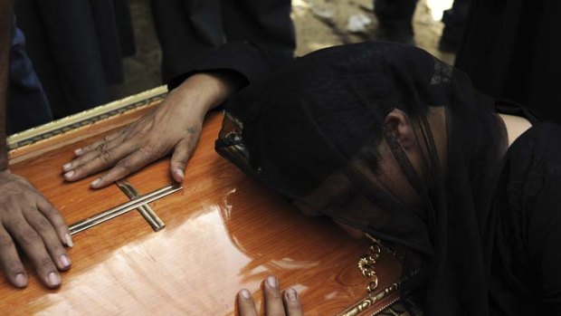 Grief overwhelms a Coptic woman at the funeral of a relative killed in the Cairo protest.