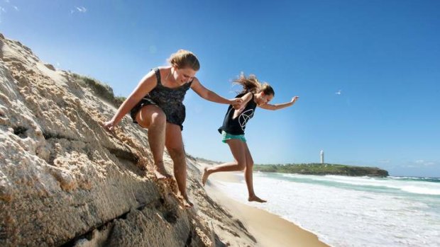 Eroded sand: Ashleigh Smith (left) and Michaela Norris play at City Beach, Wollongong.
