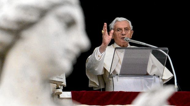 Pope Benedict XVI blesses faithfuls from the window of his apartment.