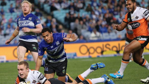 Touchdown: Jacob Liddle scores for the Tigers in their clash with Canterbury Bulldogs on Saturday.