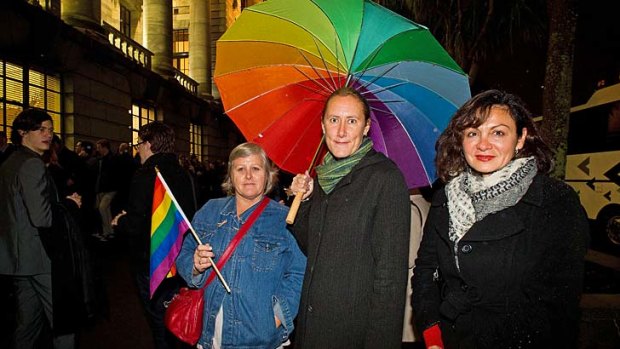 True colours: Supporters of the same-sex marriage laws wait outside parliament building in Wellington. The act is expected to see many same-sex couples from Australia cross the Tasman to tie the knot.