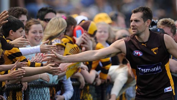 Back in the game: Hawthorn's Luke Hodge with fans during the final training session before tomorrow's Grand Final.