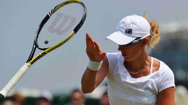 Australian Anastasia Rodionova takes her frustration out on her racquet during her loss to China's Li Na on Saturday.