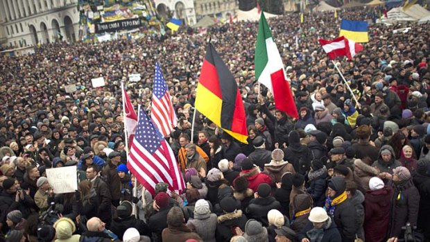 Protesters holding flags from USA, Germany and Italy, arrive at Independence Square during a rally in Kiev, Ukraine.