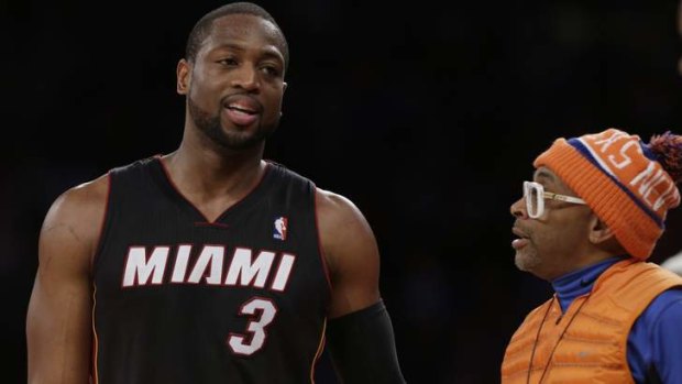 Miami Heat's Dwyane Wade talks to movie director Spike Lee during the second half against the New York Knicks in New York. The Knicks won the game 102-92.
