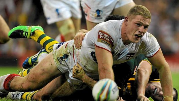 Strong game: George Burgess scores a try for England.
