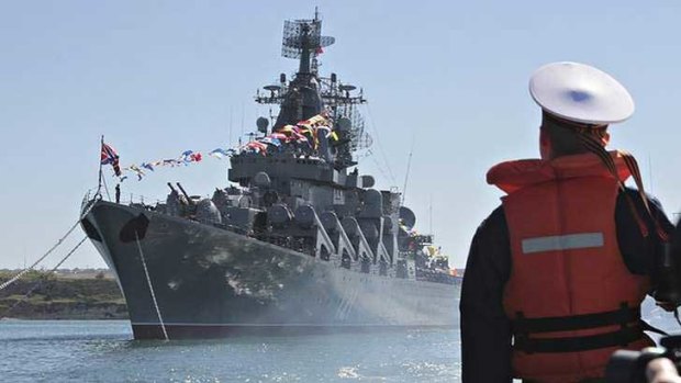 A sailor looks at the Russian missile cruiser Moskva moored in the Ukrainian Black Sea port of Sevastopol.