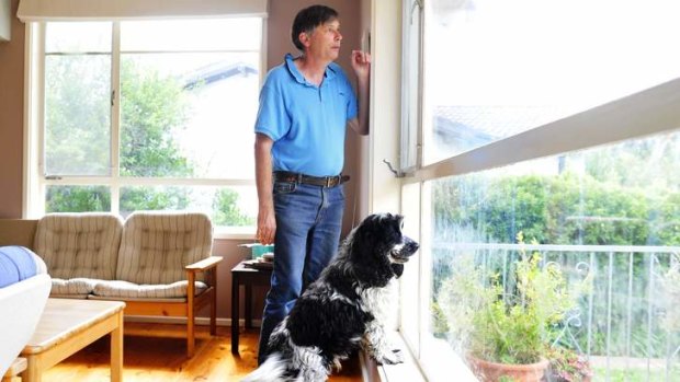 THE DANGER WITHIN: Tim Lyon and his dog, Max, at their Pearce home, which contains loose amosite asbestos.