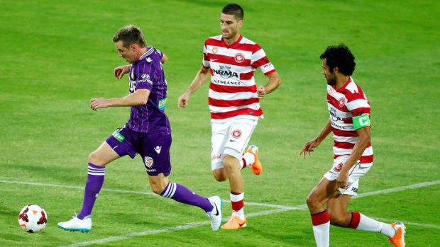 Fighters: Wanderers players attack Shane Smeltz of the Glory.