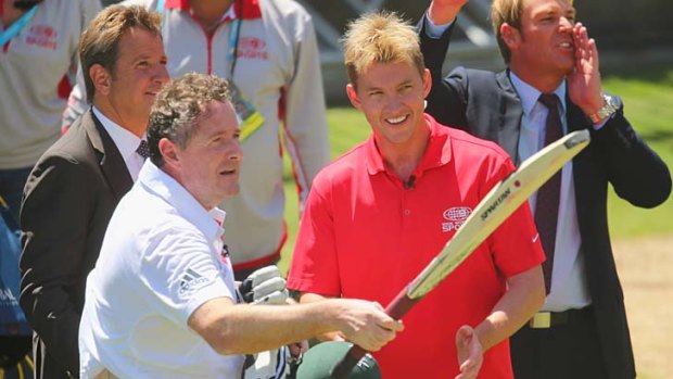 Piers Morgan salutes the crowd after 'surviving' an over from Brett Lee.
