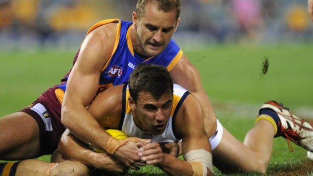 Elliot Yeo from West Coast wrestles Joel Patful from Brisbane for control of the football.