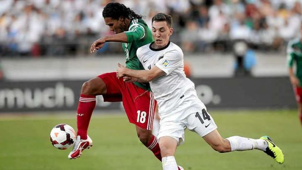 Mismatch: Craig Henderson of New Zealand fights for the ball with Edwin Hernandez of Mexico during their World Cup qualifying playoff in Wellington.