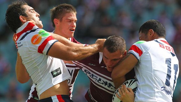 Choc'n'roll ... Anthony Watmough tries to barge his way past Braith Anasta and Frank Nu'uausala.