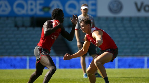 Aliir Aliir tangles with Cameron Sinclair at Swans training.