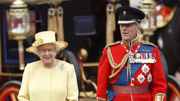 It takes two ... the Queen and Prince Philip take a salute as the Guards march past Buckingham Palace after the Trooping The Colour parade in London at the weekend.
