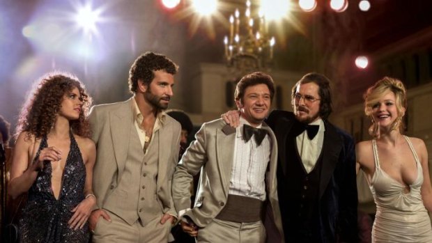 Already getting Oscars buzz: From left, Amy Adams, Bradley Cooper, Jeremy Renner, Christian Bale and Jennifer Lawrence in a scene from David O. Russell's <i>American Hustle</i>, which received seven Golden Globe nominations.