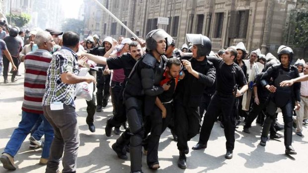 Police detain a supporter of ousted Egyptian President Mohamed Mursi during clashes in central.