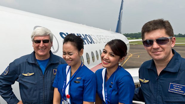 In this photo released by Sergey Dolya, captain pilot Alexander Yablontsev, left and first officer Alexander Kotchetkov pose with unidentified cabin crew next to their Sukhoi Superjet-100.